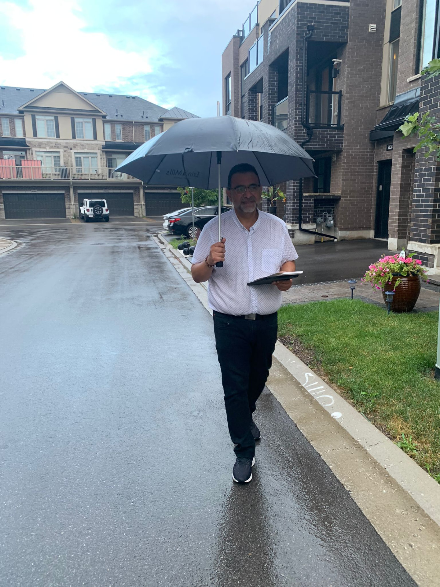 Amir Henry door-to-door canvassing in the rain