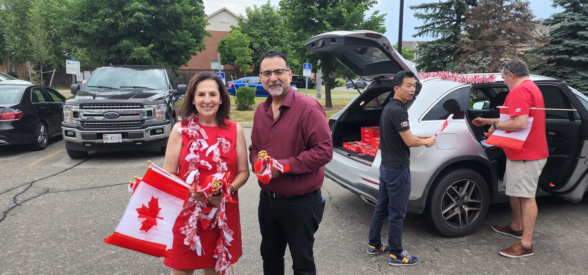 Amir Henry handing out Canada Day flags with volunteers