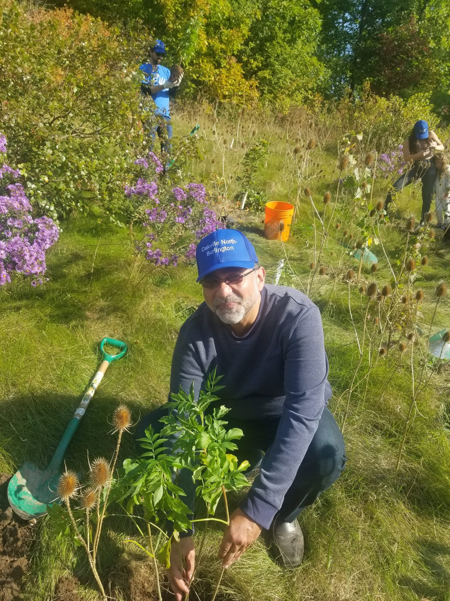 Amir Henry planting trees at a community tree-planting event