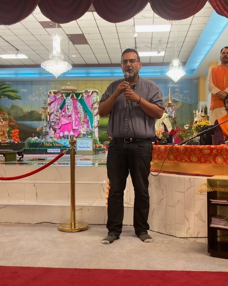 Amir Henry speaking at a temple event